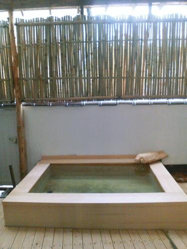 a large pool of water in a room at Kamesei Ryokan in Chikuma