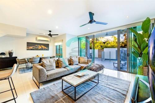 a living room with a couch and a table at ZEN ARCTIC Luxury 2-Story T/House + Pool & Markets in Fannie Bay