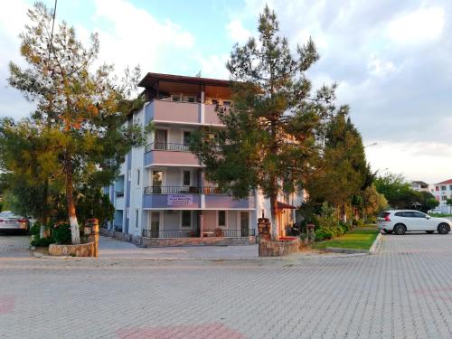 a building on a street with trees in front of it at Sagas Termal Butik Otel in Karahayit