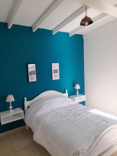 a blue bedroom with a bed and two night stands at Barra Tres in Tandil