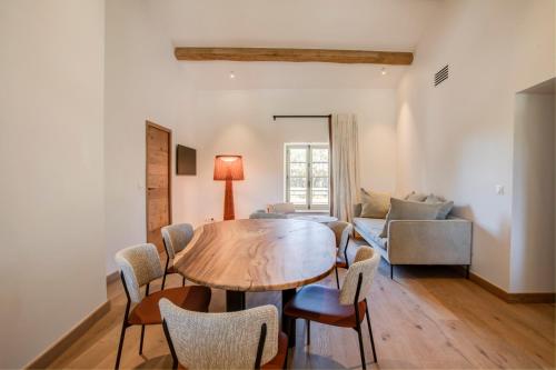 a living room with a table and chairs and a couch at Domaine de Panery in Pouzilhac