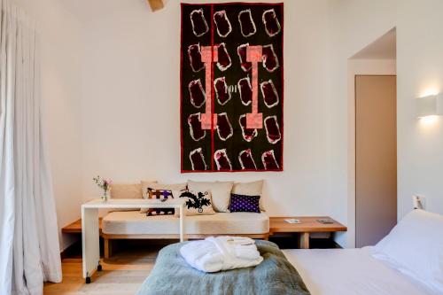 a bedroom with a bed and a table and a couch at Domaine de Panery in Pouzilhac