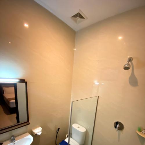 a bathroom with a shower and a sink at Omah Watu Homestay in Yogyakarta