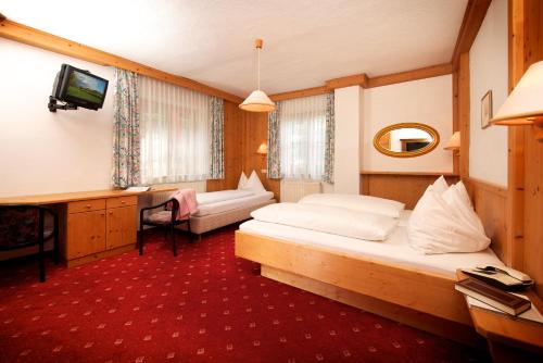 a hotel room with a bed and a television at Hotel Grafenwirt in Wagrain