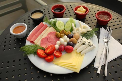 a plate of cheese and fruit on a table at HaciBayramHotel in Istanbul