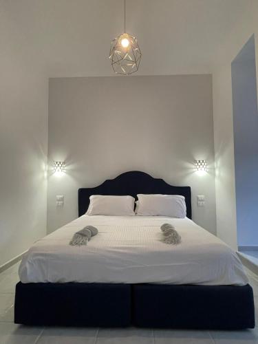 a bedroom with a large bed with a black headboard at CASAMALFITANA I DOGI in Maiori