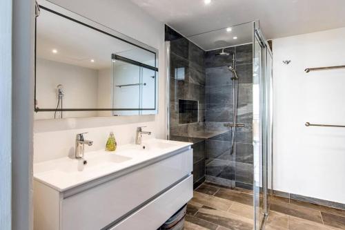 a bathroom with a sink and a shower at The Beach Penthouse in Willemstad