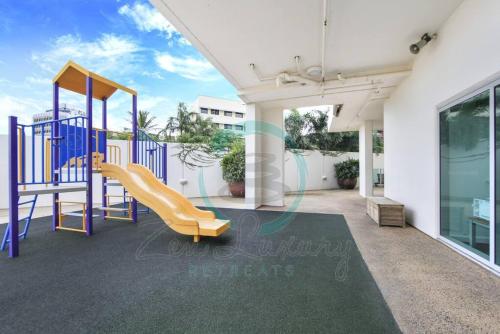 a playground with a slide on a balcony at ZEN SEA BREEZE - Darwin's Premier Family Apt in Darwin