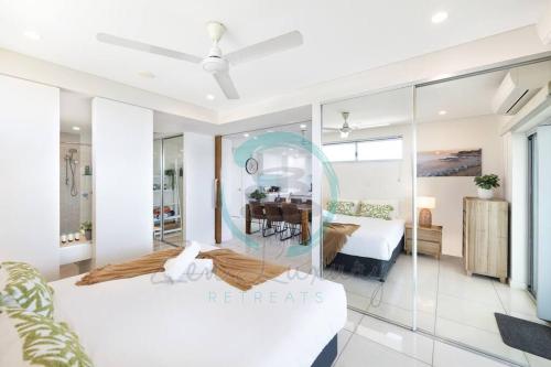 a bedroom with a bed and a mirror at ZEN SEA BREEZE - Darwin's Premier Family Apt in Darwin