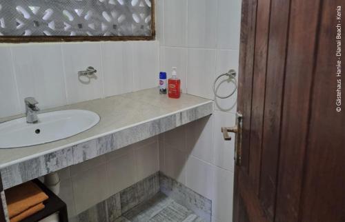 a bathroom with a sink and a counter top at Gästehaus Diani in Diani Beach