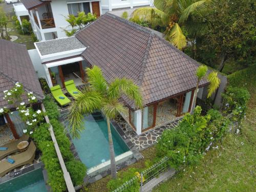an aerial view of a house with a swimming pool at Wide Sands Beach Retreat in Pulukan