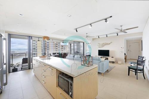 a kitchen and living room with a view of the ocean at ZEN PARADISE - 2-BR Waterfront Ocean View Retreat in Darwin