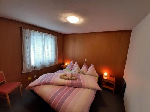 a bedroom with a bed with two stuffed animals on it at Chalet apartment by Interlaken. Parking in Ringgenberg
