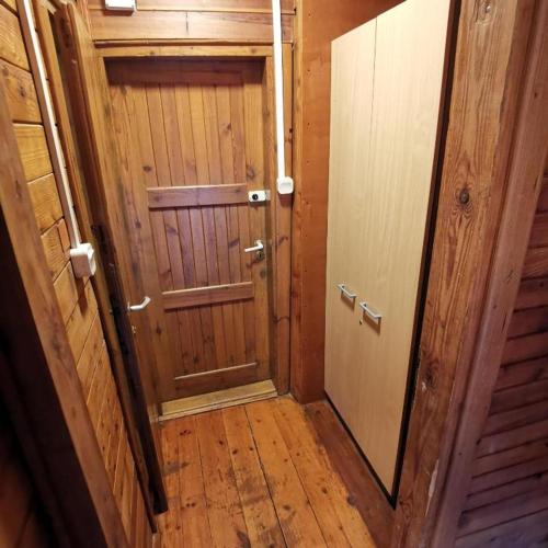 a wooden hallway with a door and a mirror at SzSM Hadle Szklarskie in Hadle Szklarskie
