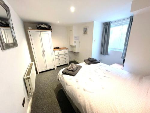 a bedroom with a bed with two towels on it at Llewellyn Avenue Apartment in Llandudno