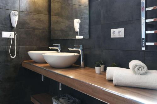 a bathroom with two sinks on a wooden counter at Villa Mica in Tijarafe