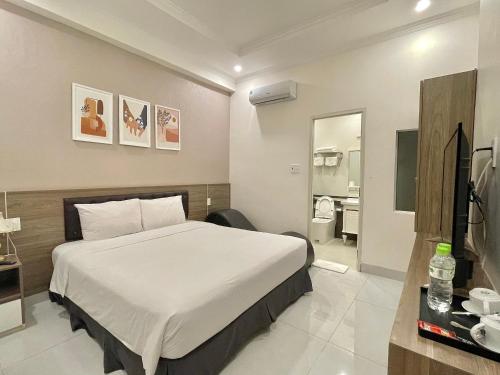 a hotel room with a bed and a bathroom at Amora Hotel & Apartment in Vung Tau