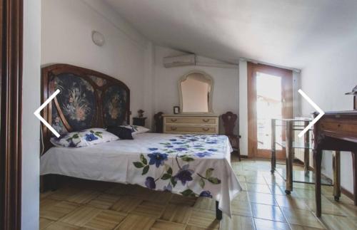 a bedroom with a bed and a dresser and a piano at Panoramico a Monte Argentario in Porto Santo Stefano