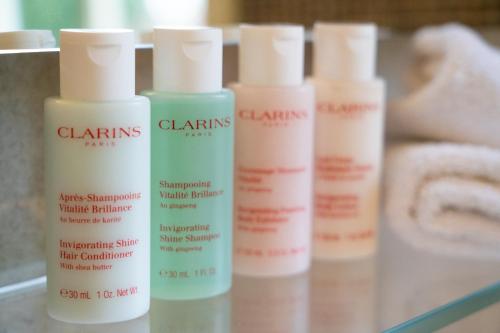 a group of four bottles of hair products on a shelf at Grays Court Hotel in York