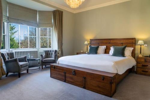 a bedroom with a large bed and a large window at Grays Court Hotel in York