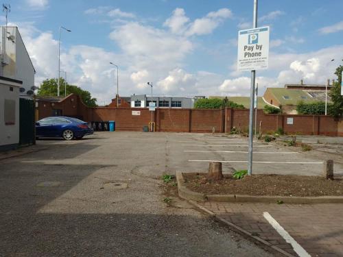 a parking lot with a parking sign in a parking lot at City Apartments Charles Street in Hull