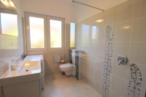 a bathroom with a toilet and a sink and a shower at MILAN A4, 50 m from the beach in Novigrad Istria