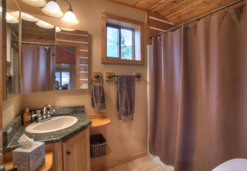 a bathroom with a shower and a sink at Stapp Mountain Retreat in South Fork, CO in South Fork