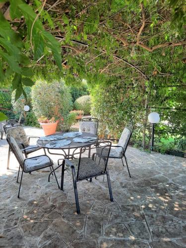 a table and chairs on a stone patio at Trullo Leone in Martina Franca