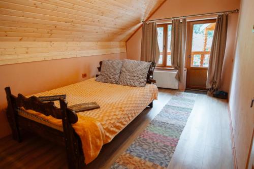 a bedroom with a bed in a wooden room at Садиба над потоком in Lumshory