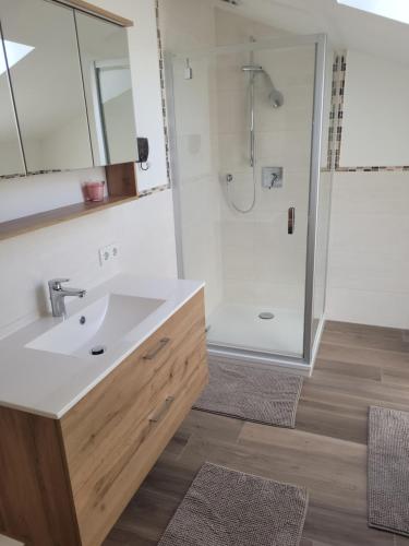 a bathroom with a sink and a shower at Ertlhof Rottau in Rottau