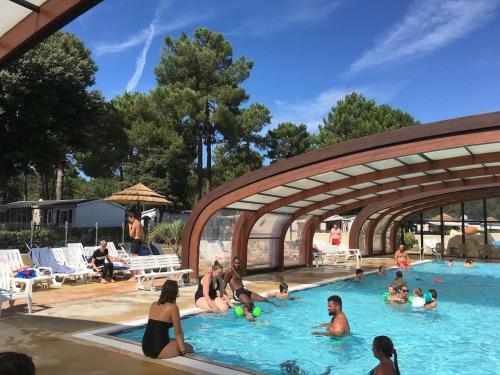 a group of people sitting in a swimming pool at Plaisirs Nature à La Pignade in Ronce-les-Bains