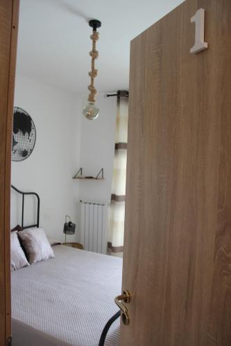 a door leading to a bedroom with a bed at bariairport in Bari