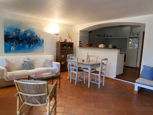 ラマチュエルにあるFERME DU MOULIN ROUX- 2 spacieux appartements- 2cbres chacun- Authentique ferme provençale- RAMATUELLEのリビングルーム(白いソファ、テーブル付)