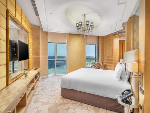 a hotel room with a bed and a television at The Venue Jeddah Corniche in Jeddah