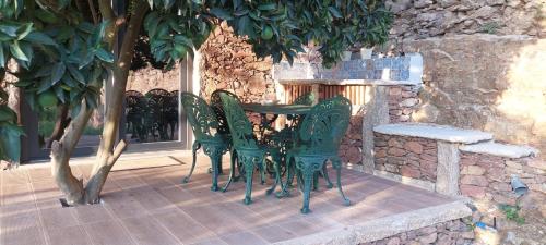 a green table and chairs on a patio at Casa da Pena in Mondim de Basto
