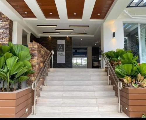 a hallway in a building with potted plants at Budget Friendly Studio Unit Staycation, Matina Enclaves Residences in Davao City