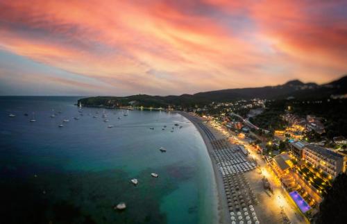a view of a beach at night with boats in the water at Ionion Beach Resort in Parga