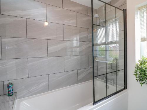 a bathroom with a tub and a glass shower at Spire Haven in Chesterfield