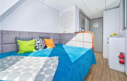 a bedroom with a bed with colorful pillows on it at 2 Bedroom Gorgeous Ship In Blotnik in Błotnik