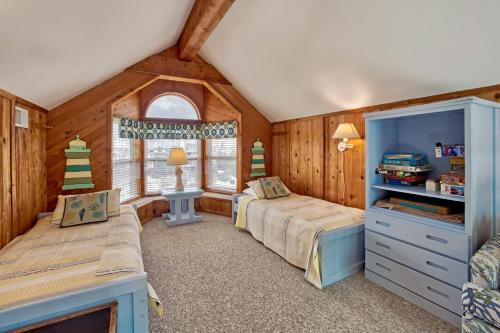 a bedroom with two beds and a window at Sandfiddler 175 in Avon