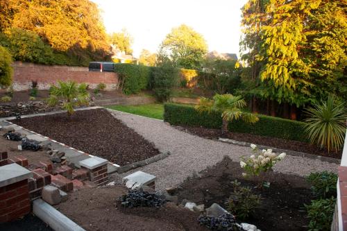 a garden with a landscaped yard with a brick wall at The Old Mount Manor - Causeway Coast in Coleraine
