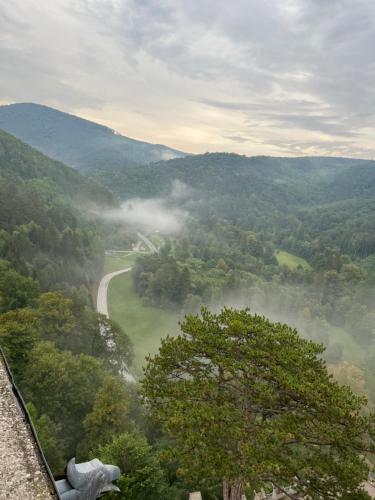 a view of a misty valley with a road at Skigebiete Stuhleck und Semmering,Wandergebiete Schneeberg und Rax in Neunkirchen
