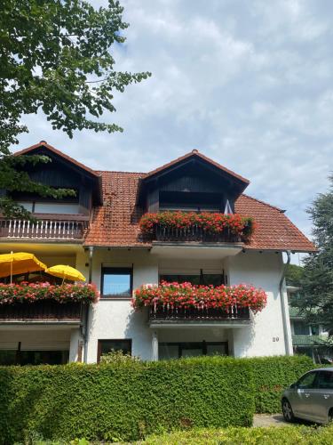 a house with flower boxes on the side of it at Apartment am Park in Bad Lauterberg