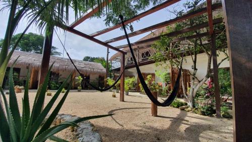 a resort with a rope hanging from a building at Cedro Rojo in Bacalar