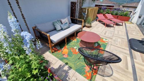a patio with a bench and a table and chairs at Boutique B&B and Wellness la Casa dei 5 Elementi in Giubiasco