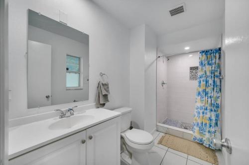 a bathroom with a sink and a toilet and a shower at House in Tampa with Private Pool and more in Tampa