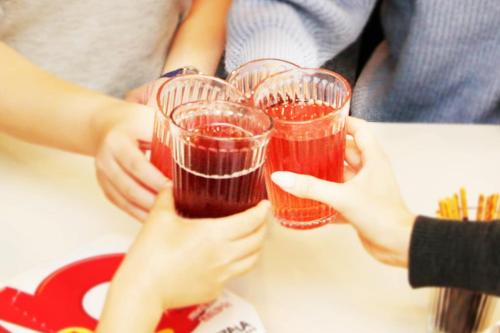 a group of people holding up wine glasses at SG Premium KASAI in Tokyo
