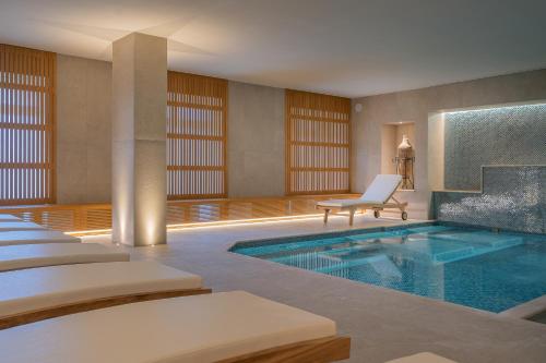 a hotel room with a swimming pool and a chair at Hotel Mary in Vico Equense