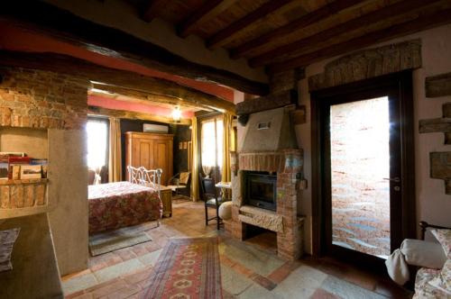 a bedroom with a fireplace and a bed in a room at La Via' in Cavour