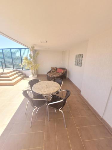 a room with a table and chairs on a balcony at Lets Idea Brasília Hotel By Rei dos Flats in Brasília